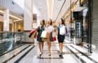 Young women walking through a shopping centre
