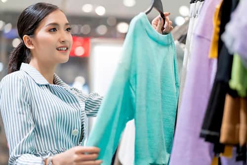 Woman choosing clothes in a retail boutique